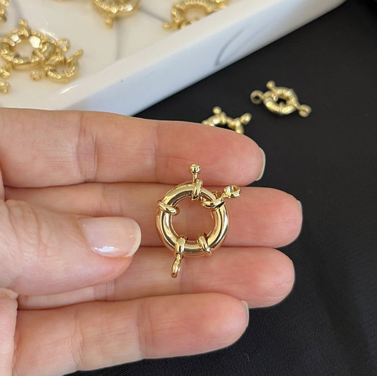 Close-up view of 18K gold filled sailor clasps showing detailed craftsmanship and golden finish