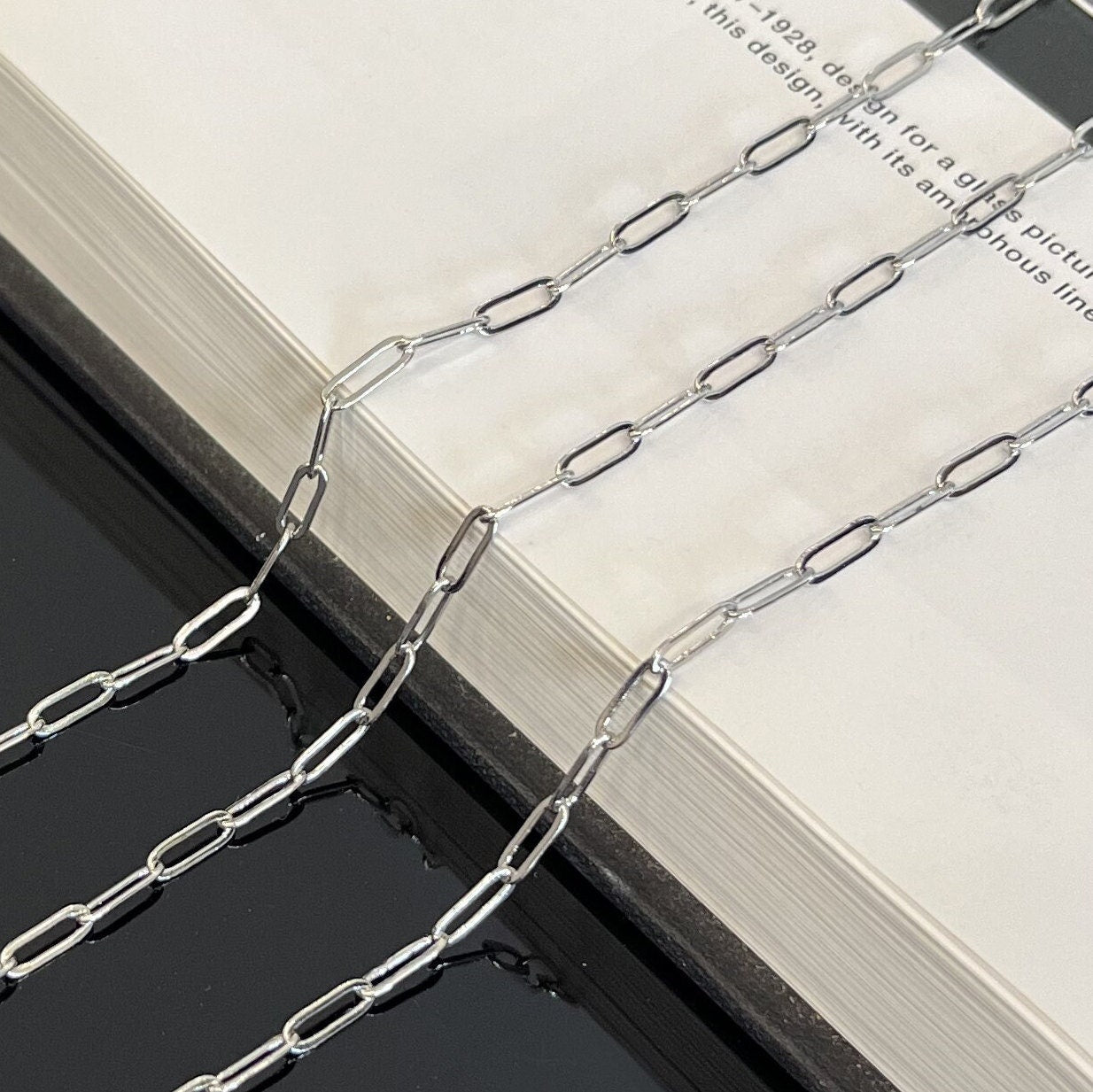 Close-up detail of 9x3mm sterling silver paperclip chain showing oval link pattern