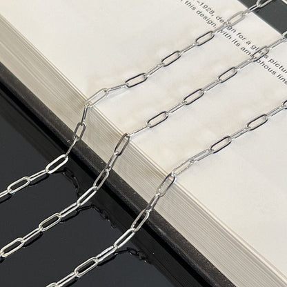 Close-up detail of 9x3mm sterling silver paperclip chain showing oval link pattern
