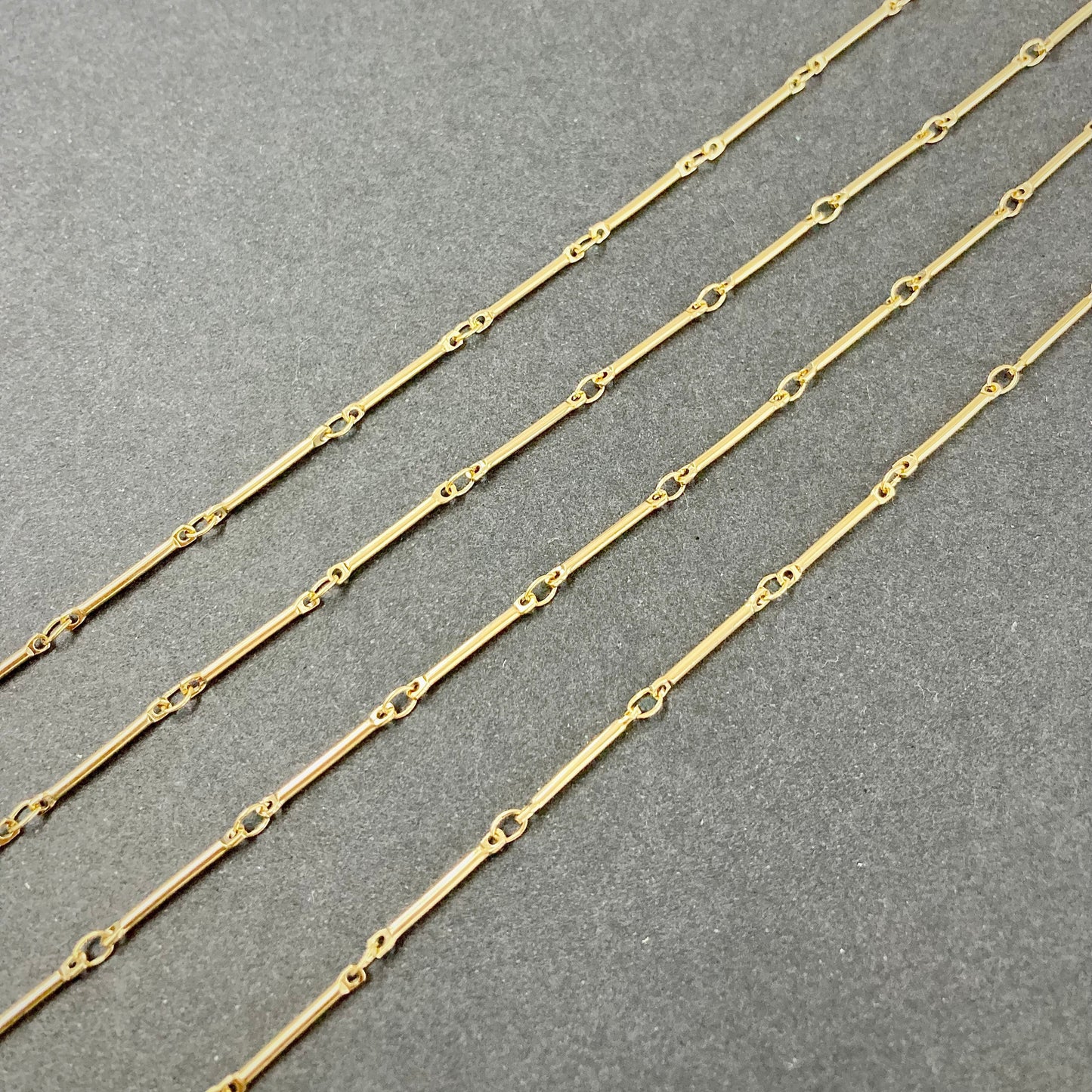 Gold bar chain on a gray background