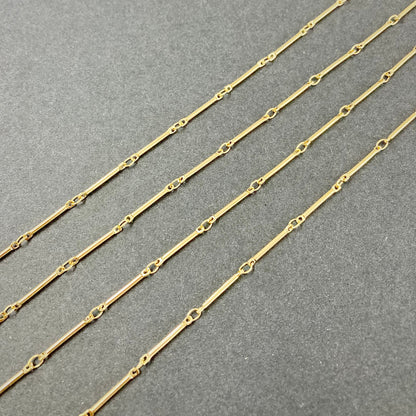 Gold bar chain on a gray background