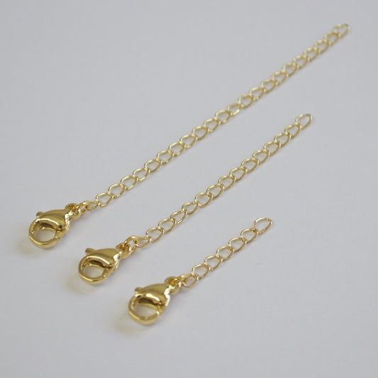 Gold chain with clasp on a light gray background