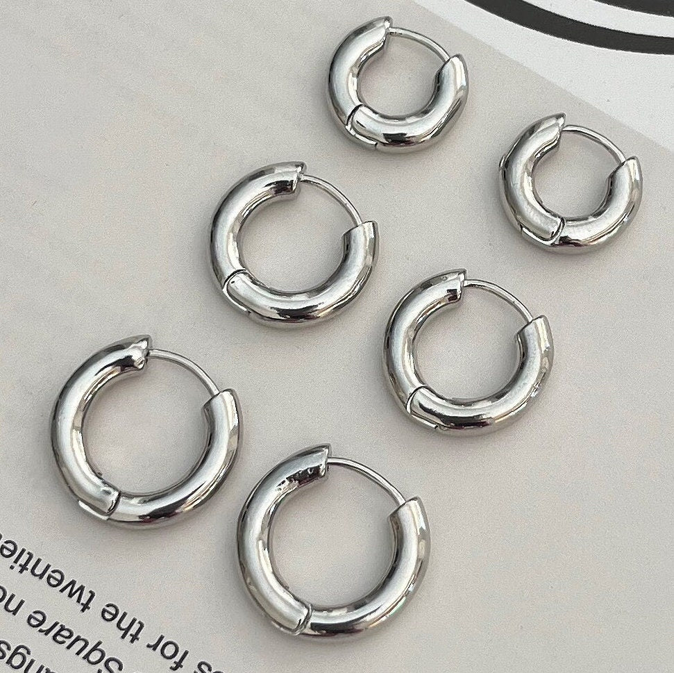 Sterling silver thick huggie hoop earrings - side angle view showing sleek design