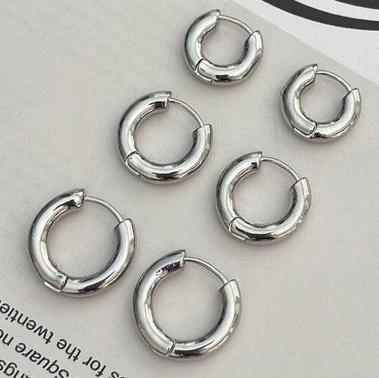 Sterling silver thick huggie hoop earrings - side angle view showing sleek design