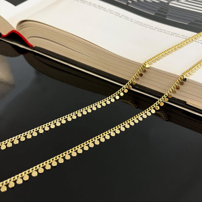 Close-up detail of 18K gold filled coin chain showing disc texture and finish