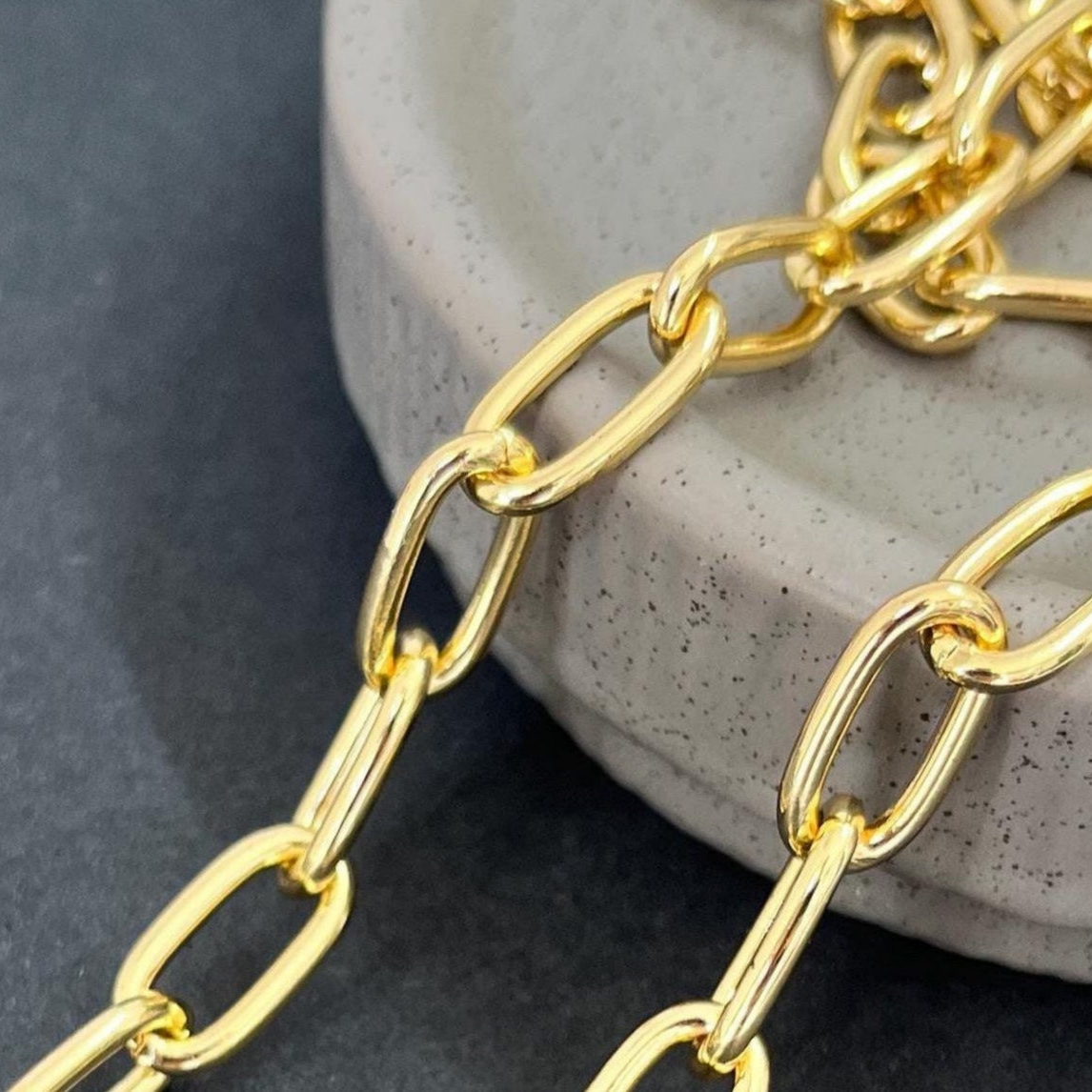 Gold chain on a textured stone surface