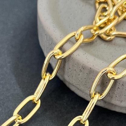 Gold chain on a textured stone surface