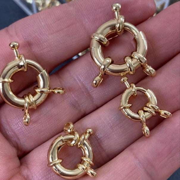 18K gold filled sailor clasps held in hand demonstrating size and quality