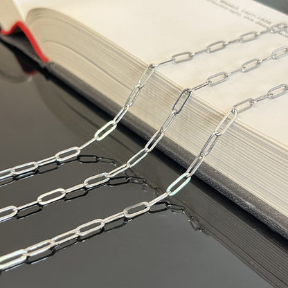 Sterling silver paperclip chain 9x3mm oval links displayed flat showing chain texture