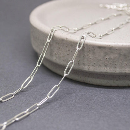 9x3mm sterling silver paperclip chain with oval links on white background